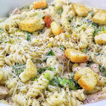 Creamy One Pot Chicken Caesar Pasta with tender seasoned chicken, penne pasta, Parmesan cheese, Caesar dressing, chopped romaine and crunchy croutons.