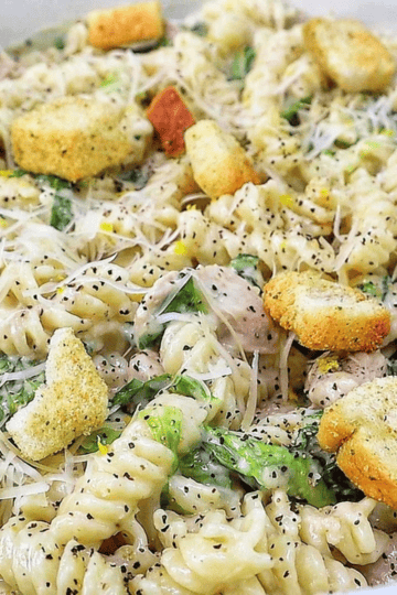 Creamy One Pot Chicken Caesar Pasta with tender seasoned chicken, penne pasta, Parmesan cheese, Caesar dressing, chopped romaine and crunchy croutons.