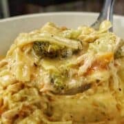Creamy Broccoli Cheddar Lasagna Soup served in a white bowl with shredded chicken, tender lasagna noodles, broccoli florets and carrots in a rich cheddar cheese broth.